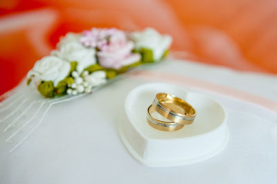 Close-up of wedding rings in heart shape jewelry box