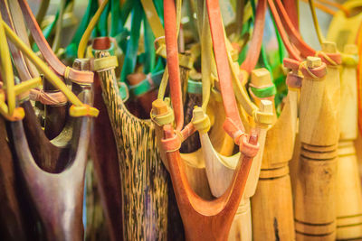 Close-up of clothes hanging on wood at store