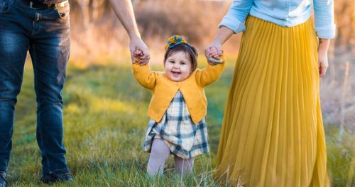 Full length of a smiling young woman holding grass