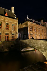 Reflection of buildings in water at night