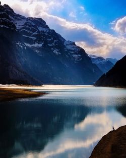 Scenic view of lake and mountains against sky