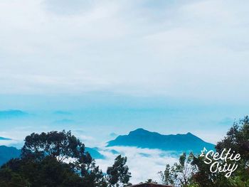 Scenic view of mountains against cloudy sky