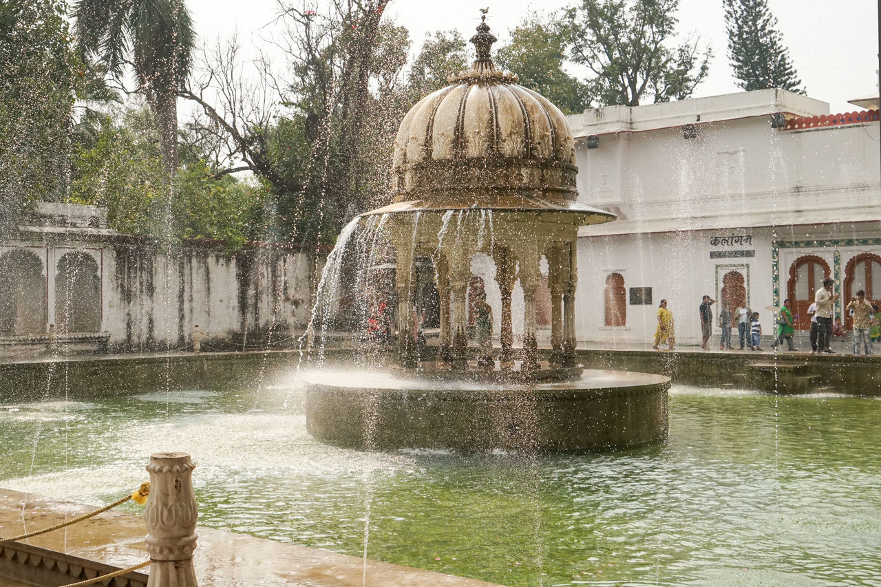 water, architecture, built structure, fountain, travel destinations, building exterior, tree, nature, plant, tourism, water feature, travel, religion, history, day, the past, spraying, motion, place of worship, outdoors, dome, belief, group of people, city, sky, spirituality, building, palace, pond, splashing