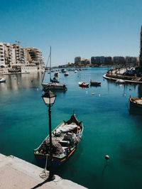 Boats moored at harbor