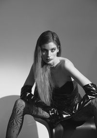 Young woman sitting on sofa