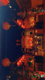 Illuminated lanterns hanging in store at night