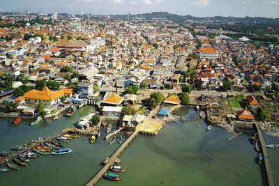 High angle view of townscape by sea in city