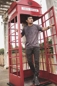 Portrait of young man standing against wall