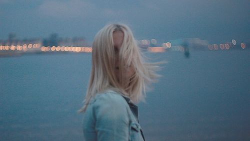 Rear view of woman standing in water