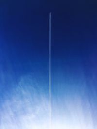 Vapor trail against blue sky