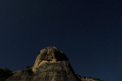 Low angle view of mountain against sky at night