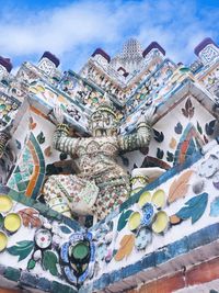 Low angle view of sculptures on building against sky