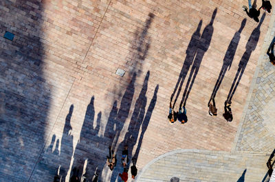 Directly above shot of people on street with shadow