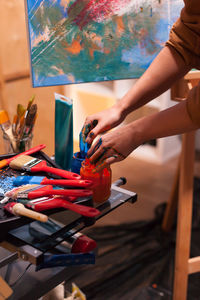 Midsection of woman painting on table