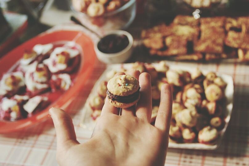 person, food and drink, food, sweet food, holding, freshness, indoors, part of, indulgence, dessert, unhealthy eating, ready-to-eat, cropped, focus on foreground, personal perspective, lifestyles, unrecognizable person