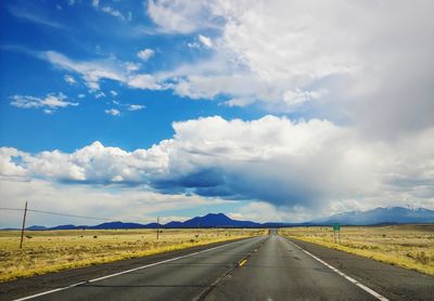 Empty road along countryside landscape