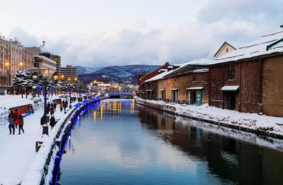 Buildings in city against sky during winter