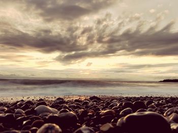 Scenic view of beach against sky during sunset