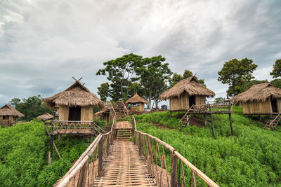 House amidst trees and buildings against sky