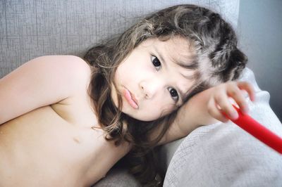 Close-up of girl lying on sofa