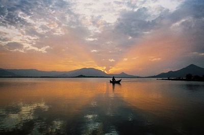 Scenic view of lake at sunset