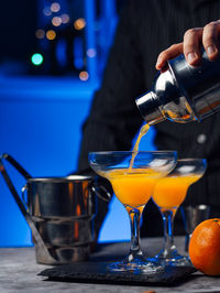 Waiter in a bar is preparing a cocktail
