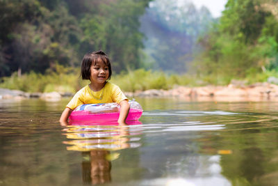 Girl with inflatable ring in lake