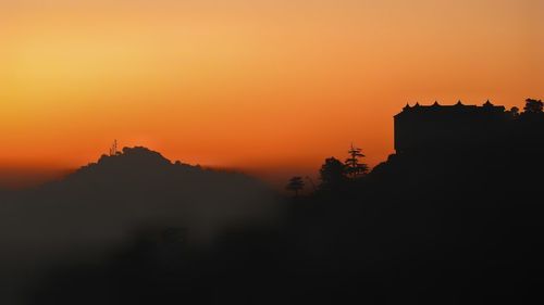 Scenic view of silhouette landscape against romantic sky at sunset