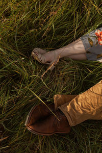 Low section of man standing on field