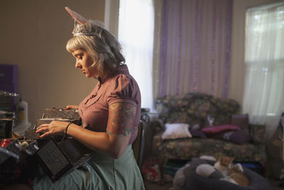 Young woman in front of mirror wearing bunny ears