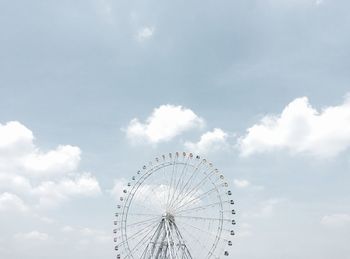 Low angle view of ferris wheel against sky