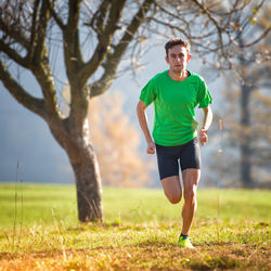 Full length of boy running on field