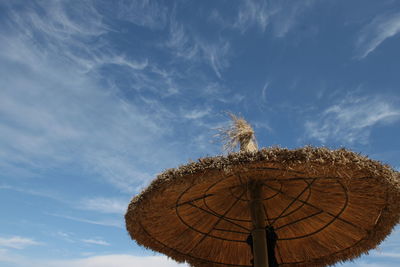 Low angle view of traditional windmill against sky