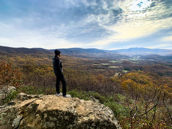 Man standing on mountain against sky
