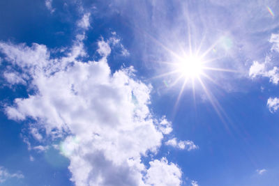 Low angle view of bright sun in sky