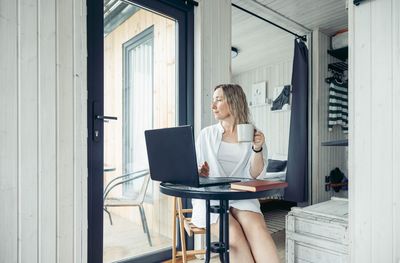 Creating a calm and focused home office environment, a woman with a laptop at a table