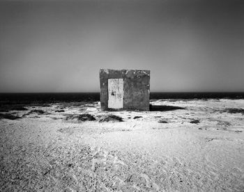 Lifeguard hut on beach against clear sky