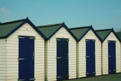 Beach huts against clear sky