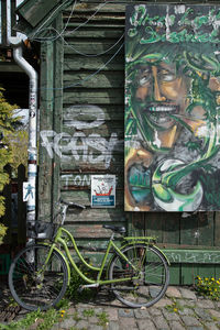 Bicycle parked against building