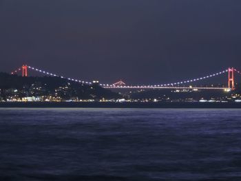 Illuminated suspension bridge over sea