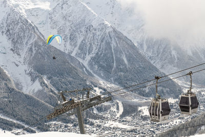 Ski lift over snowcapped mountains