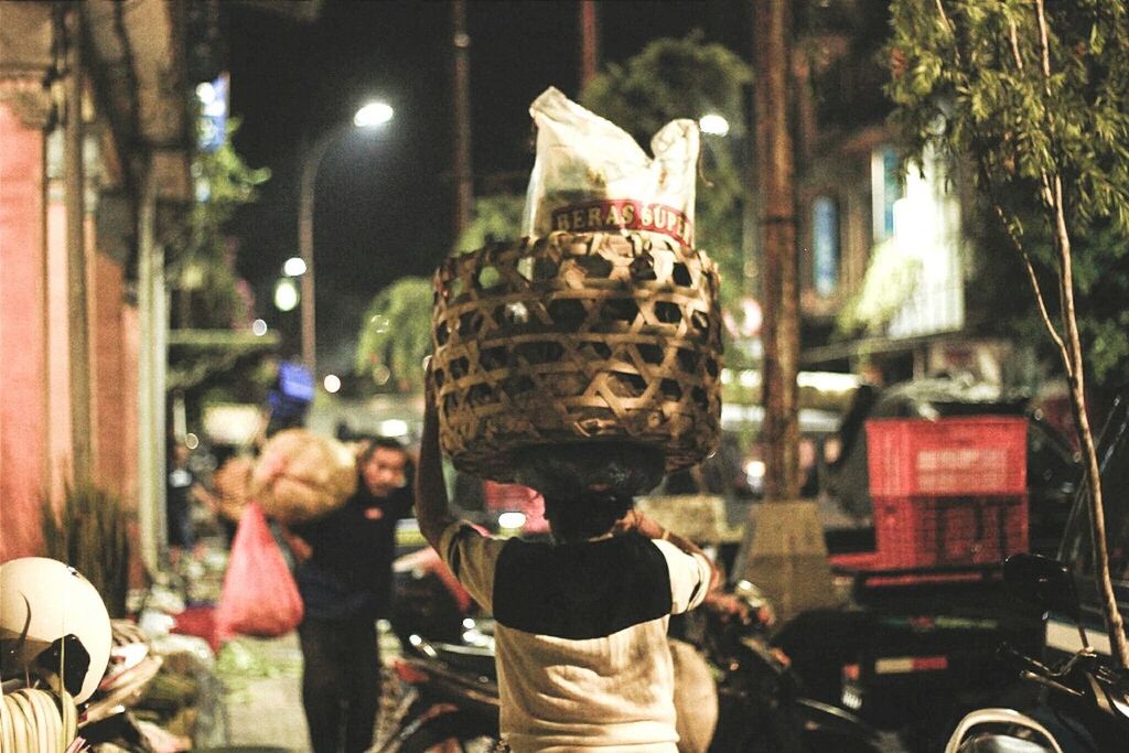 REAR VIEW OF MAN IN ILLUMINATED TRADITIONAL CLOTHING