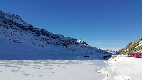 Scenic view of frozen sea against clear blue sky