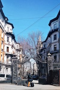Man on street amidst buildings in city