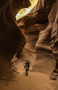 Rear view of man in cave