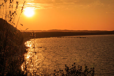 Scenic view of sea against orange sky