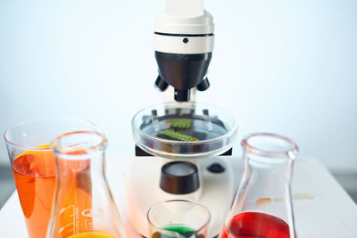 Close-up of drink on table against white background