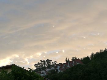 Buildings against cloudy sky