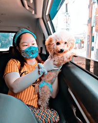 Girl with dog in car