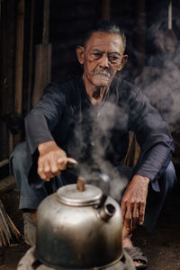 Portrait of senior man working at workshop